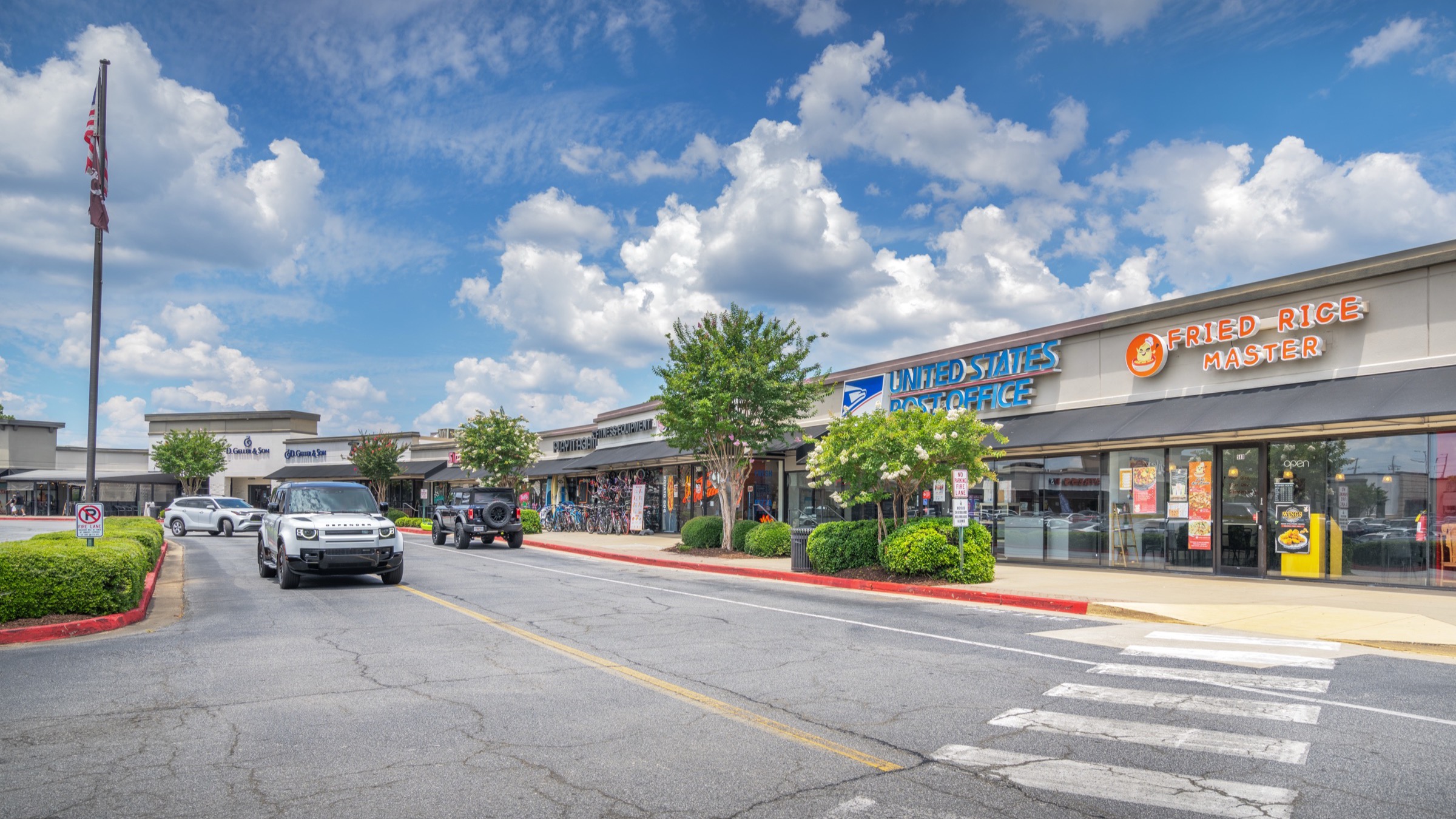 Shop frontage and parking field looking east across the center