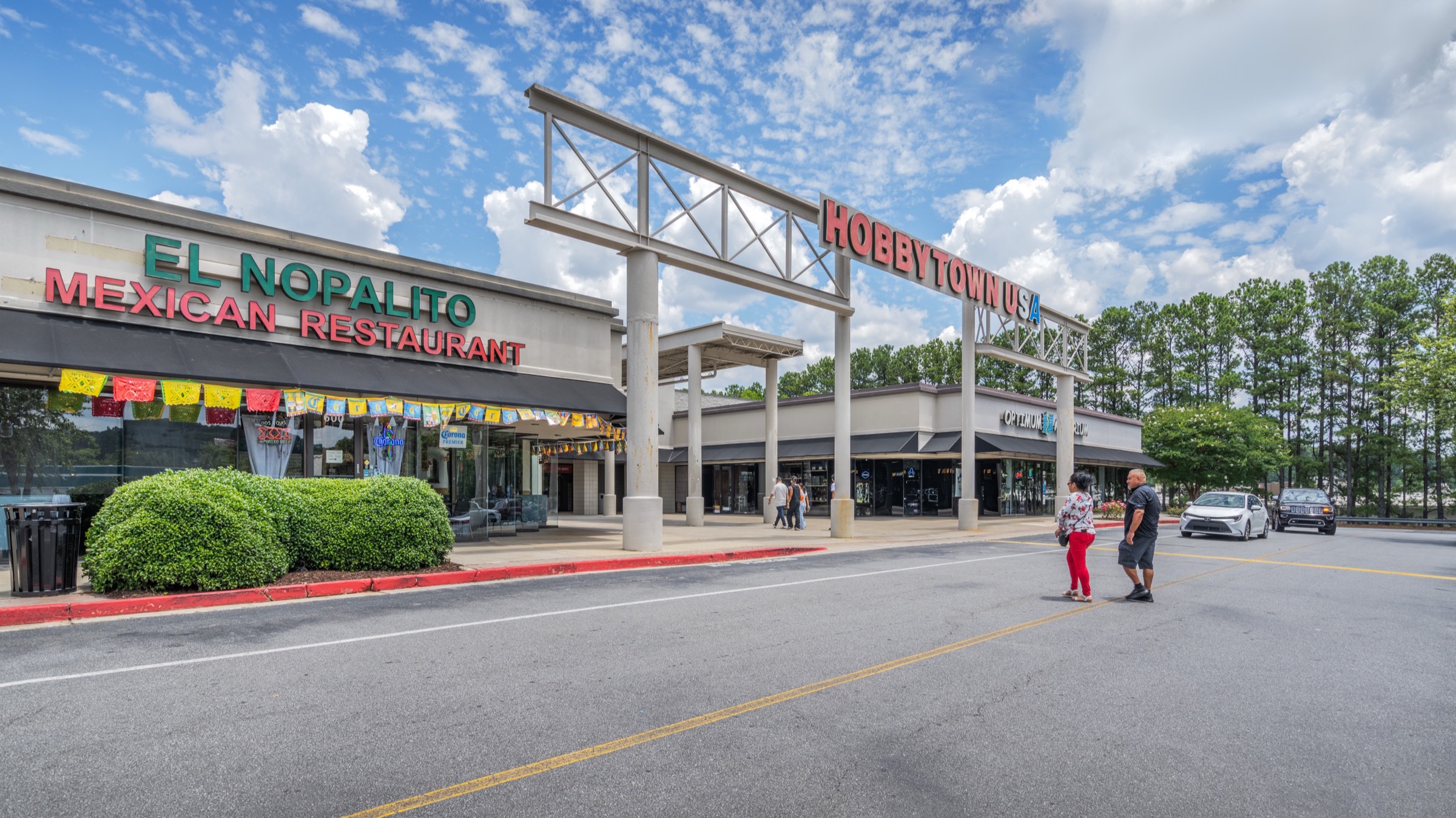 Inline shops and pylon signage along the eastern retail arc